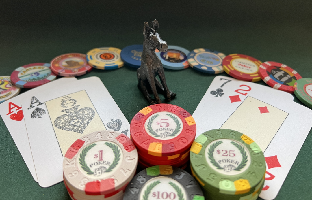 Donkey figurine on a poker table with chips and playing cards, illustrating the concept “Don’t Be the Donkey”—a metaphor for strategic discipline in energy business leadership.